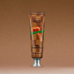 A brown tube of SOFTY HAND CREAM CARAMELT featuring an image of caramel dripping on the front, standing upright against a brown gradient background.