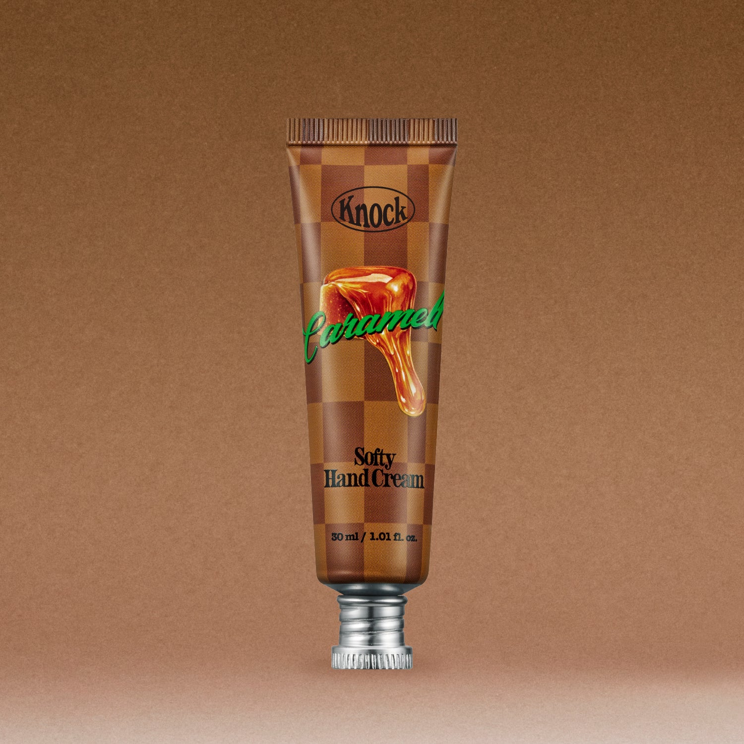 A brown tube of SOFTY HAND CREAM CARAMELT featuring an image of caramel dripping on the front, standing upright against a brown gradient background.