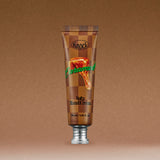 A brown tube of SOFTY HAND CREAM CARAMELT featuring an image of caramel dripping on the front, standing upright against a brown gradient background.