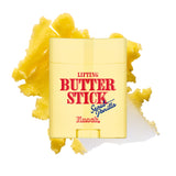 A yellow container labeled LIFTING BUTTER STICK SEOUL VANILLA sits in front of a smear of yellow butter on a white background. This sculpting stick delivers a firm finish and lifts skin for a smooth, radiant look.