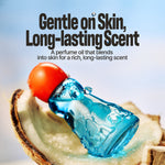 A perfume oil bottle with translucent blue liquid and a bright orange cap, resting on a slice of coconut against a soft light blue background. Large text reads, 'Gentle on Skin, Long-lasting Scent' with smaller descriptive copy below.