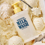 A bottle of WHIPPING MILK WASH SEOUL VANILLA with a yellow pump nestles among scoops of vanilla ice cream, seamlessly blending in with the creamy texture—a soft-foaming body wash that leaves your skin feeling as smooth and luxurious as dessert.