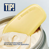 A yellow spatula labeled Scoop Me! rests in the FIRMING BODY BUTTER SEOUL VANILLA inside its container. TIP! Use the provided spatula for an easy, mess-free application and enjoy deep moisture for smooth skin.