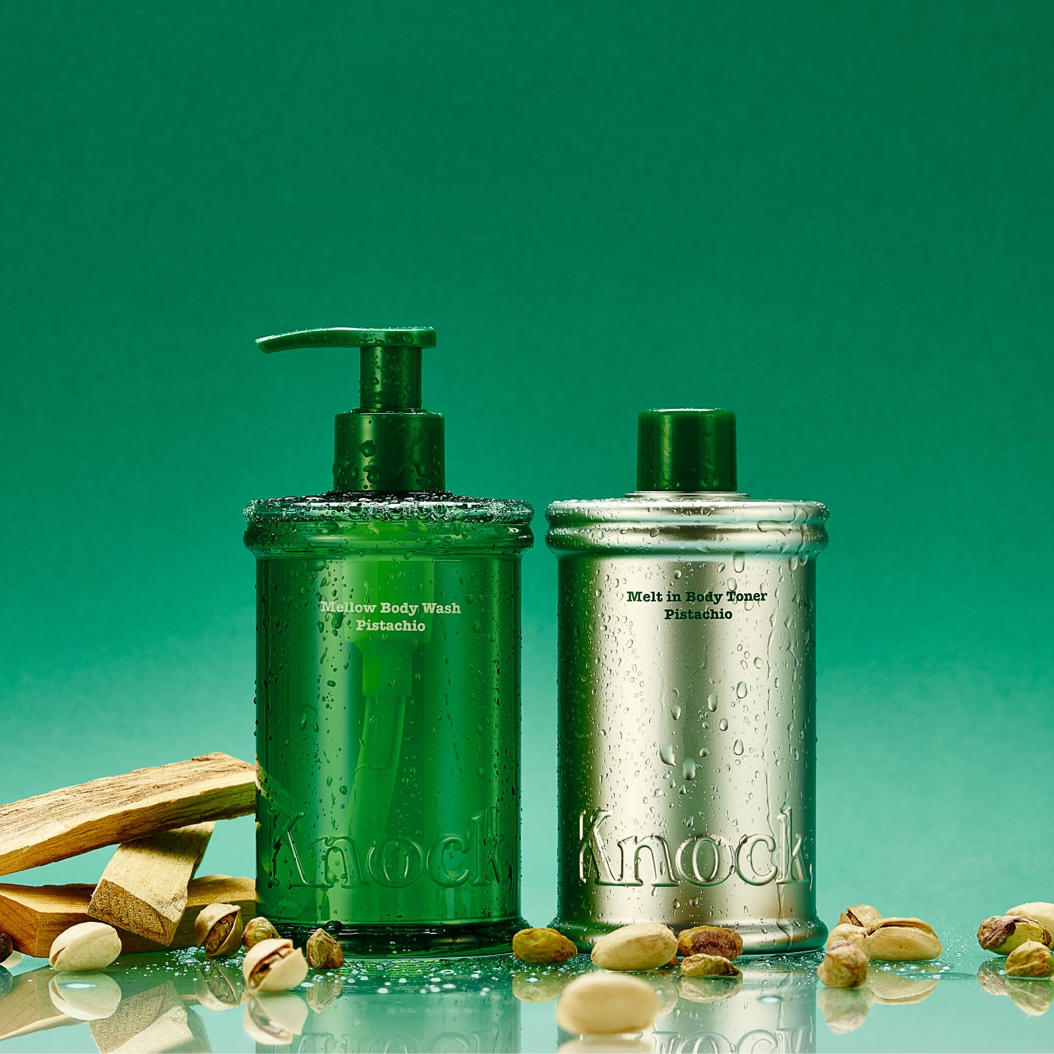 Two bottles of skincare products on a green background with pistachios.